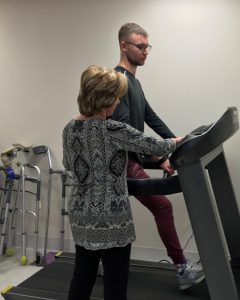 Physical Therapist at Bancroft NeuroRehab helping Johan on treadmill