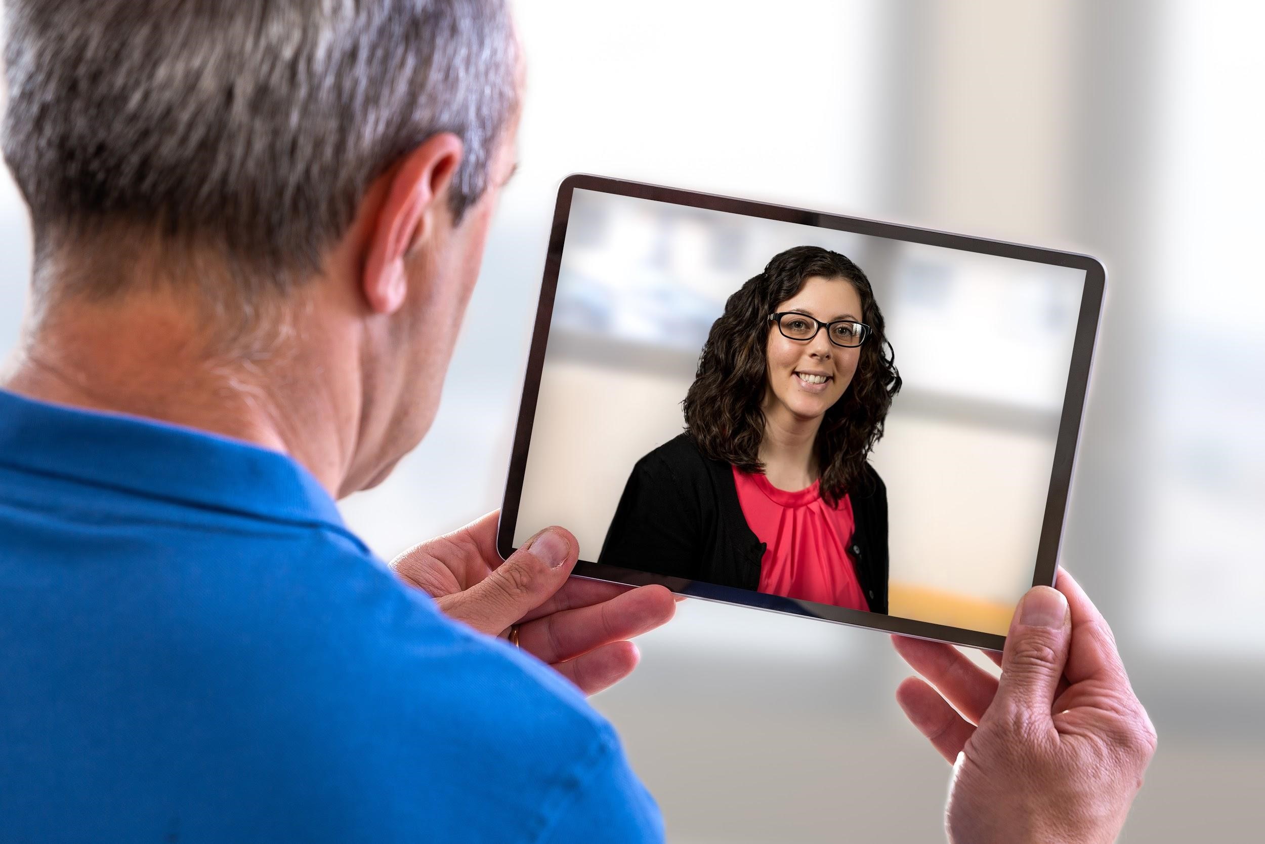 Man talking to Bancroft NeuroRehab therapist through a tablet