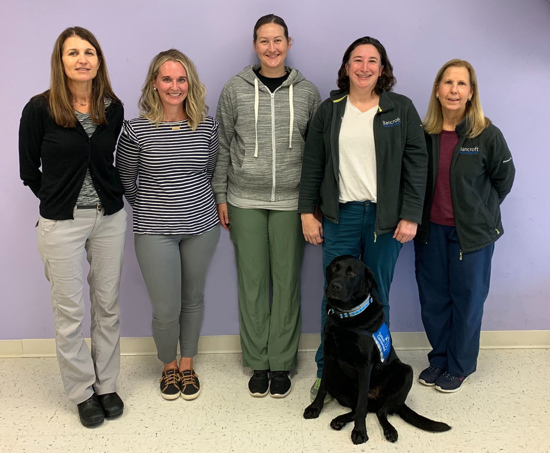 Bancroft NeuroRehab Clinicians smiling with therapy dog