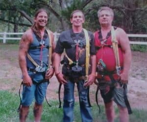A gentleman and his two sons about to go ziplining.