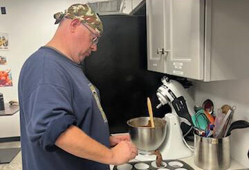 Occupational therapy - man preparing cupcakes in a kitchen